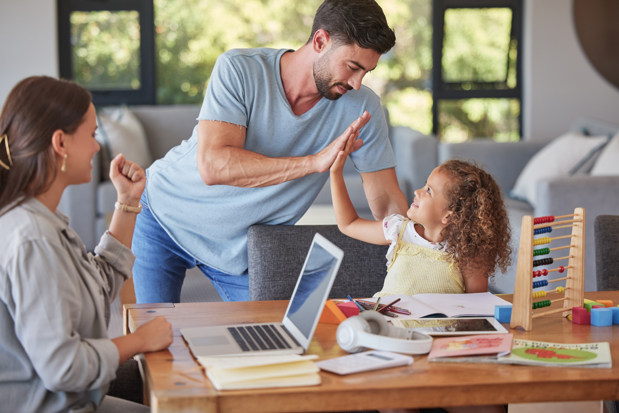 High five, family and education with a student girl learning and studying at home while her parents remote work from home. Study, school and support with a father giving motivation to his daughter.
